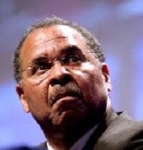 Close up of black man's face with wire rimmed glasses, a moustache and a worried or scared look as he looks up