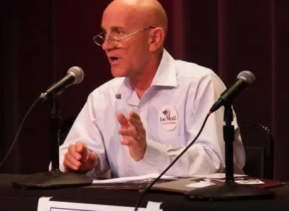 Joe Motil speaking at a podium