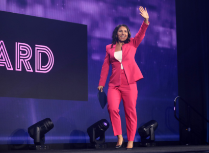 Tulsi Gabbard waving on a stage