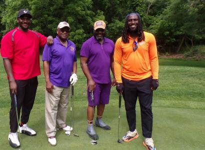 Men  posing with golf clubs