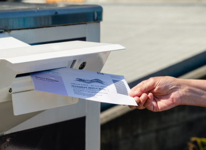 Putting a ballot in a mailbox