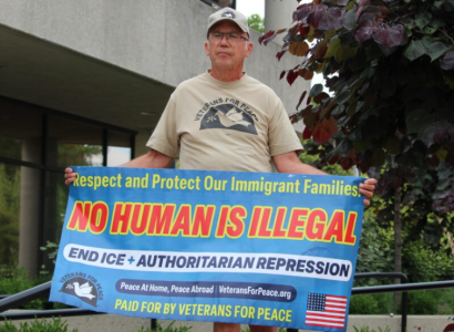 Man holding sign in support of Haitians in Springfield OH