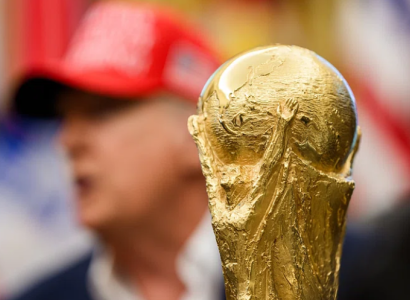 World Cup trophy with Trump blurred in the background