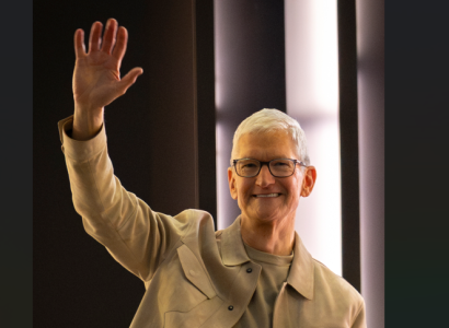 Older man raising his hand and smiling