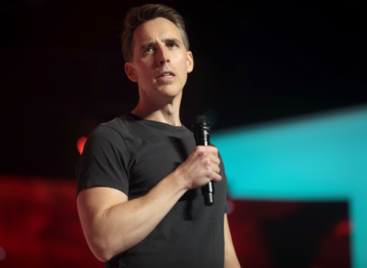 White man talking into a microphone