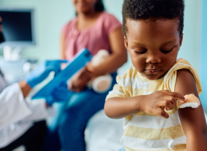 Little boy with a bandaid on his arm