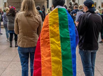 Protesters at the Ohio Statehouse one with a rainbow flag