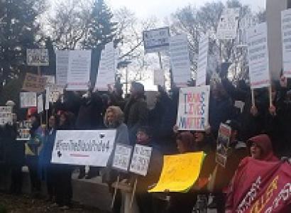 Many people holding signs outside