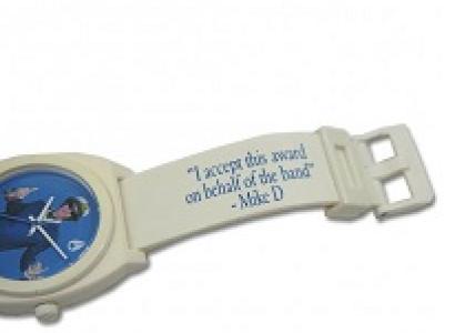 White watch and band with blue face and words I accept this award on behalf of the band Mike D