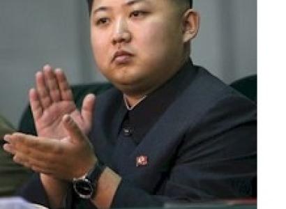 Young looking Asian man with no smile but clapping his hands