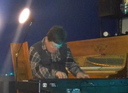 White man playing keyboards 