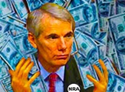 White man with gray hair and a suit with an NRA button on with dollars all around him