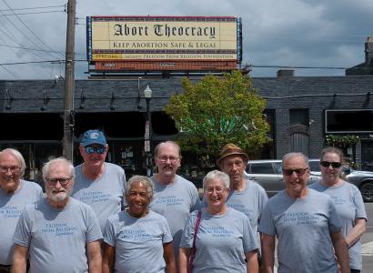 People standing in front of billboard