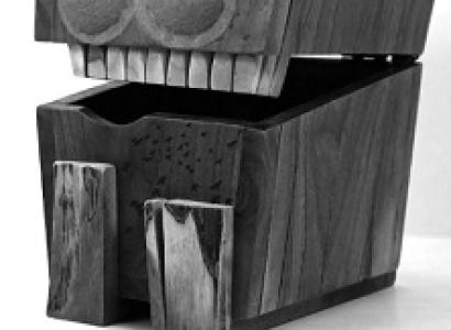 Big box with lid open and two eyes and teeth like a face