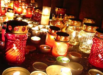 Lots of gold and red candles glowing in the dark