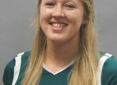 Young woman with long blonde hair in a green sports jersey 
