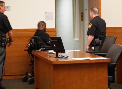 Man in wheelchair in police station