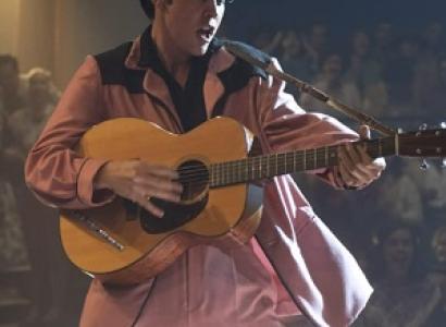 Elvis playing guitar and singing