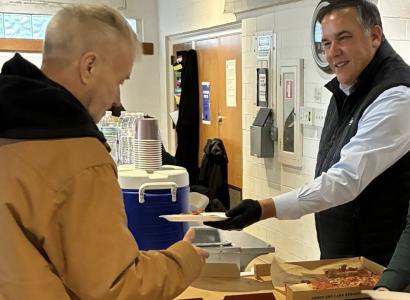 Ginther handing food to man