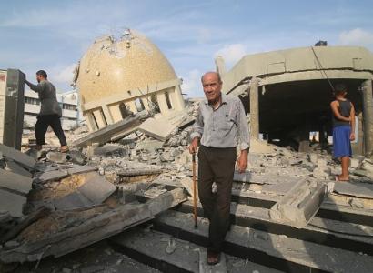 Man in front of destroyed buildings