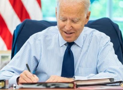 Joe Biden at desk signing something