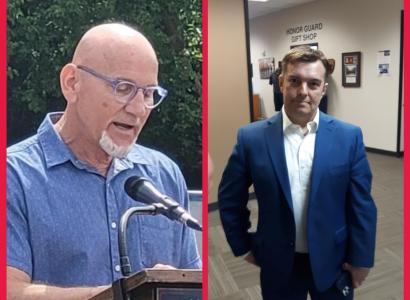 Man at a microphone and another looking on