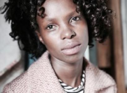 Young black woman with short ringlets and with a kind of sad expression