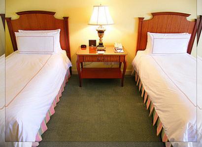 Two single beds separated in a bedroom