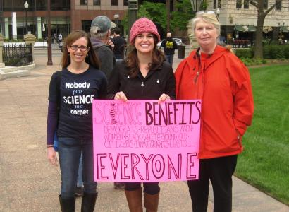 Three women holding sign that says Science Benefits Everyone