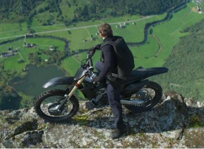 Man on a motorcycle on a cliff