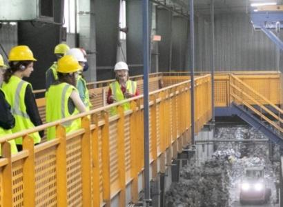 People in hard hats walking through facility