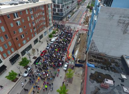 Downtown street with thousands of people marching