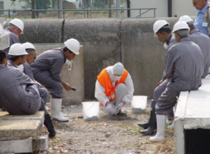 Men in hazard suits working