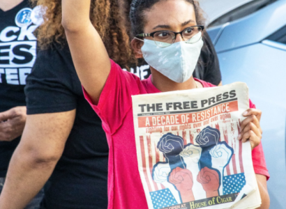 Women at protest holding Free Press