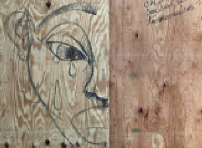 Face drawn crying on a piece of wood