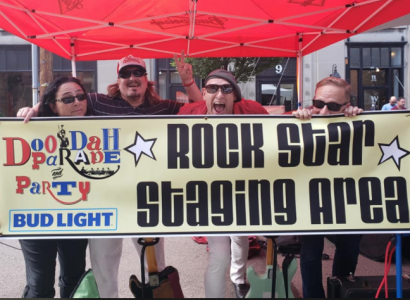 People holding sign saying Rock Star Staging Area