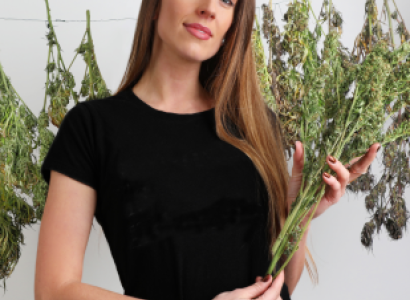 Woman holding marijuana plant