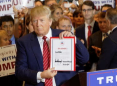 Trump holding up a sign