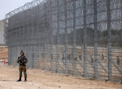 Man standing outside a wall of fences