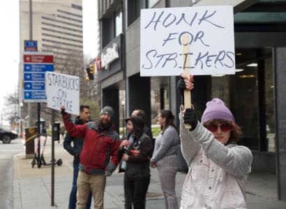 People outside striking with signs