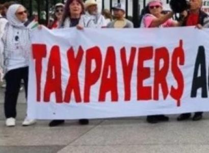 People holding Taxpayers Aganst Genocide banner