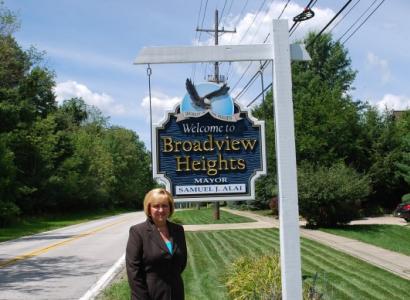 Blonde woman next to the Broadview Hts sign