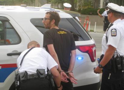 Activist being handcuffed by police
