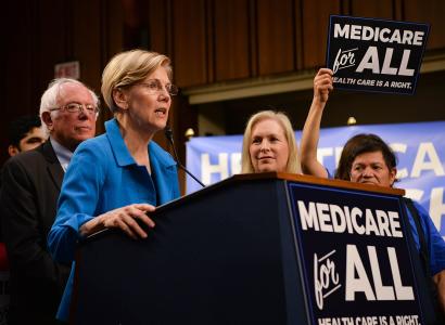 Elizabeth Wareen speaking at podium about Medicare for All