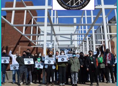 Workers holding signs outside the Wexner Center