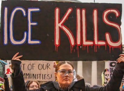 Woman with ICE Kills sign
