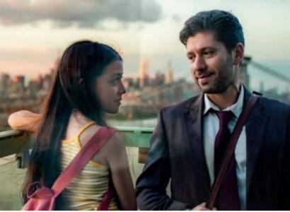 Man and young girl stand outside