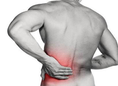 Naked man's back with red glow at the bottom and him holding it as if in pain