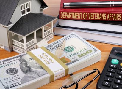 Money, house, book titled Dept of Veterans Affairs