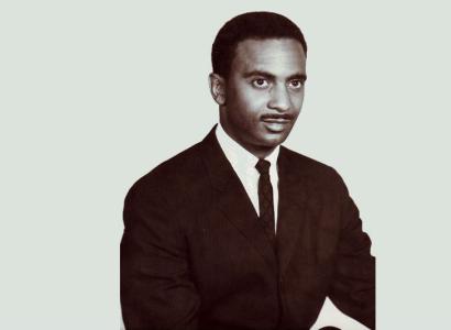 Black and white photo of young black man in a suit